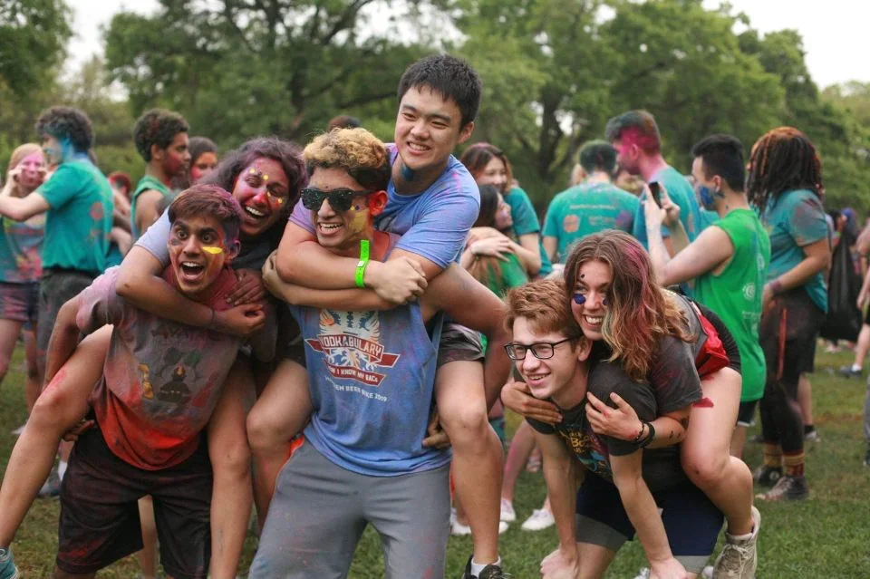 Hugh and Anna Margaret celebrating with friends at a colorful outdoor event