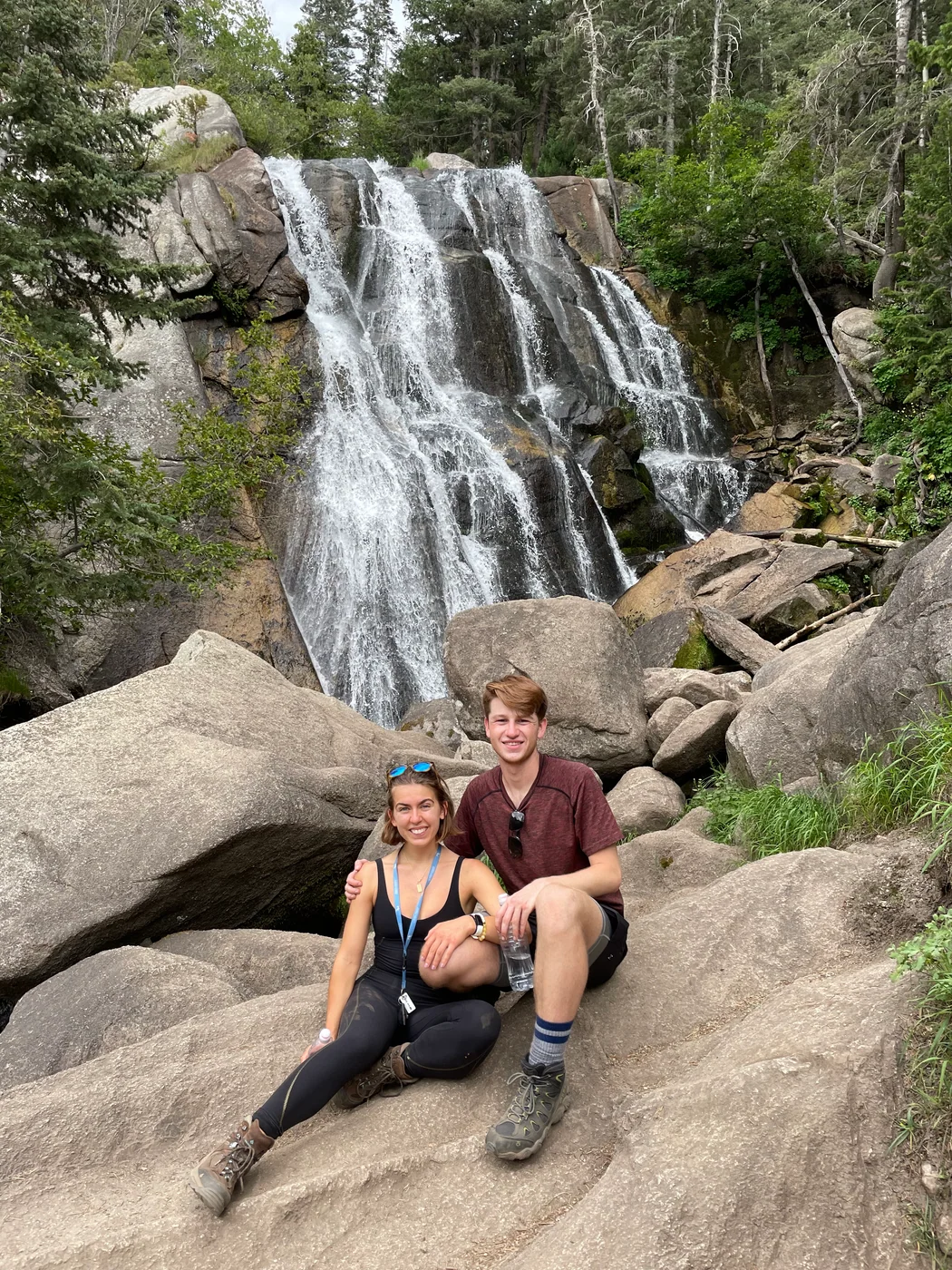Anna Margaret and Hugh beside a waterfall