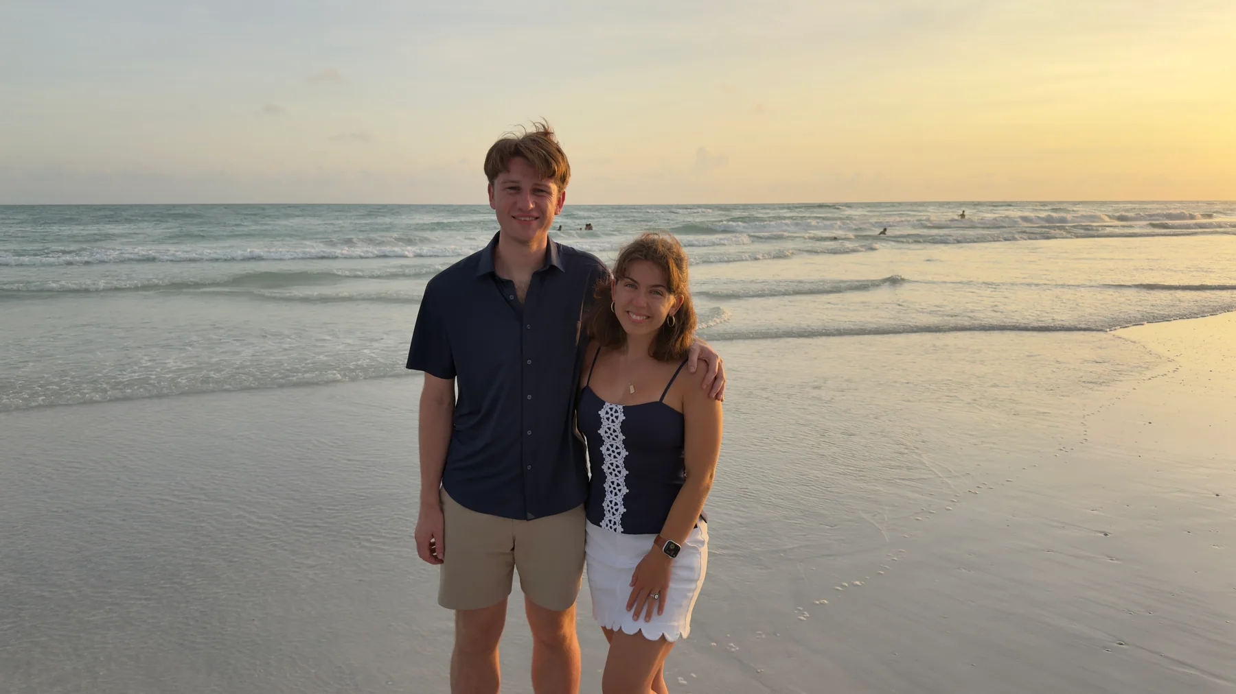 Hugh and Anna Margaret standing together on the beach at sunset