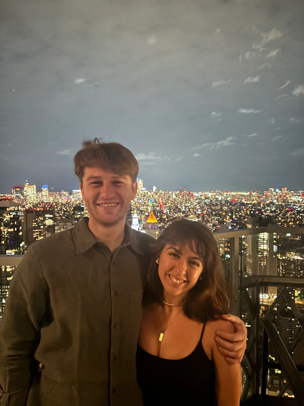 Hugh and Anna Margaret together above a glowing city skyline